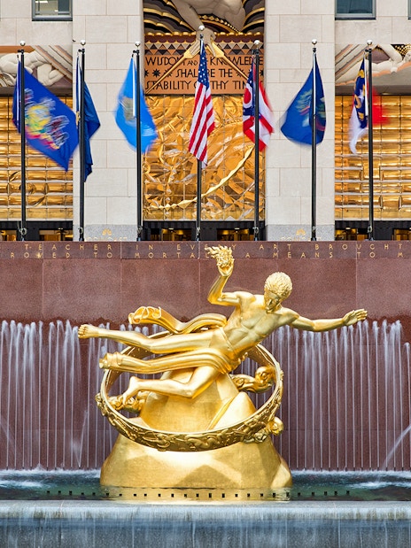 Prometheus statue and flags at Rockefeller Center, New York City.