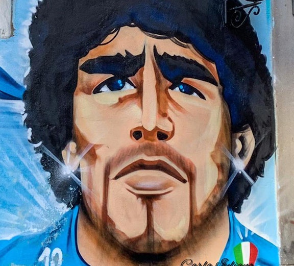 Mural of a famous footballer in Naples, Italy, featured on Maradona Tours.