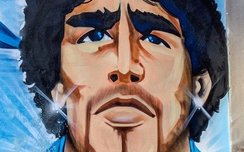 Mural of a famous footballer in Naples, Italy, featured on Maradona Tours.