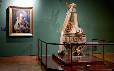 Portrait and imperial cradle display at Imperial Treasury Vienna.