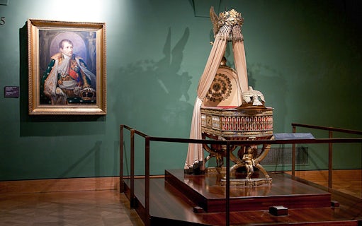 Portrait and imperial cradle display at Imperial Treasury Vienna.
