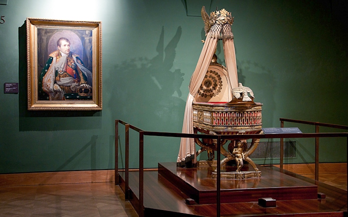 Portrait and imperial cradle display at Imperial Treasury Vienna.