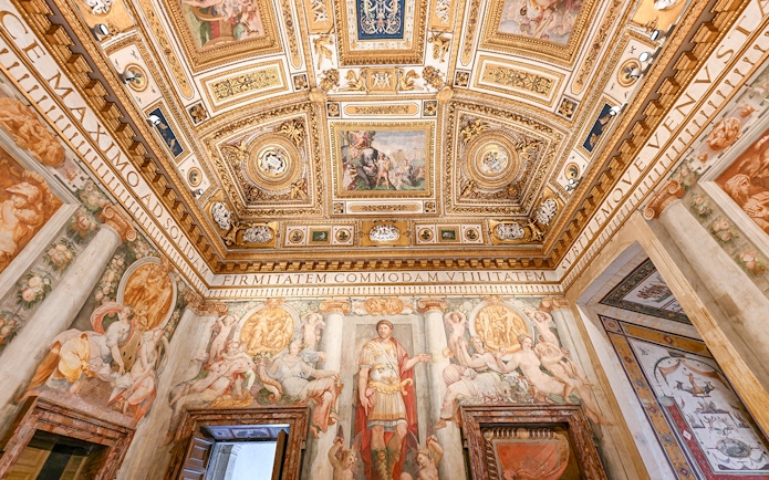 Interior of Castel Sant'Angelo featuring ornate ceiling details and frescoes in Rome, Italy.