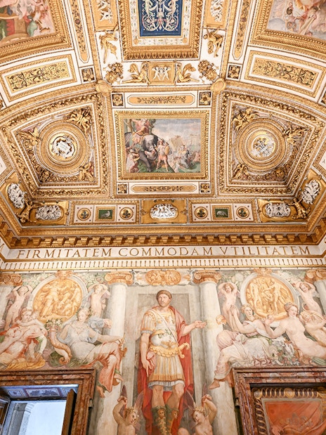 Interior of Castel Sant'Angelo featuring ornate ceiling details and frescoes in Rome, Italy.