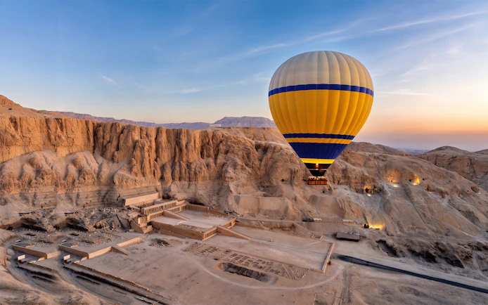 Hot air balloon over Luxor's Valley of the Kings at sunrise.