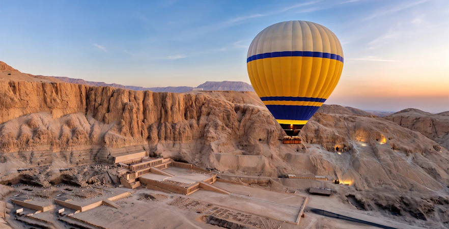 Hot air balloon over Luxor's Valley of the Kings at sunrise.