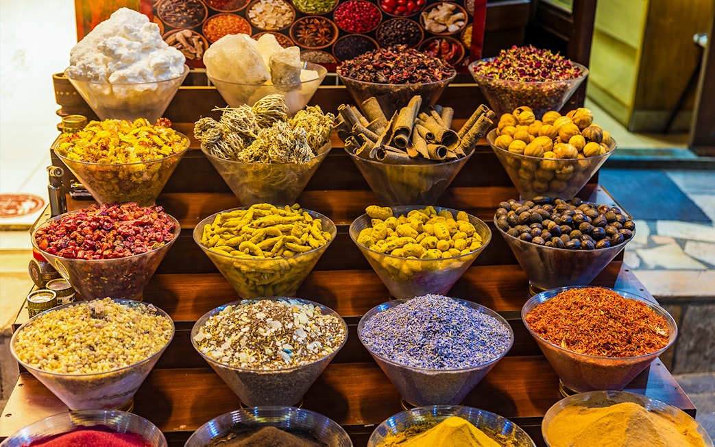 Spices displayed in bowls at a market in Dubai during a half-day sightseeing tour.