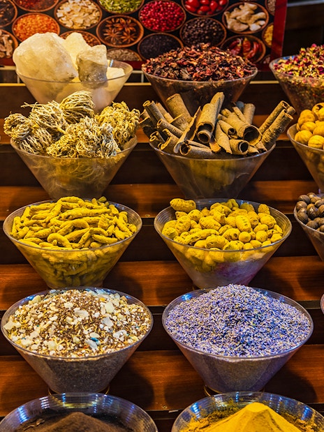 Spices displayed in bowls at a market in Dubai during a half-day sightseeing tour.