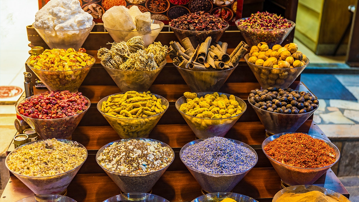 Spices displayed in bowls at a market in Dubai during a half-day sightseeing tour.