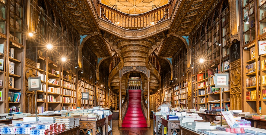 Lello Library's ornate interior with intricate wooden staircase in Porto, Portugal