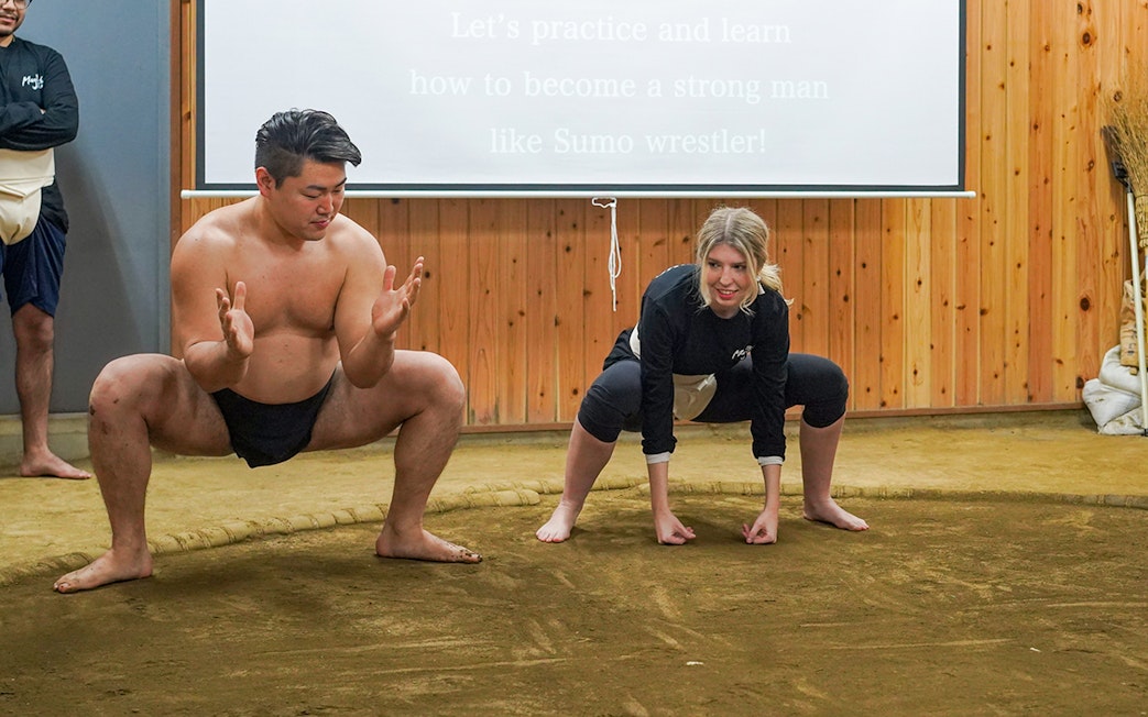 Sumo wrestler teaching a participant in a Tokyo sumo wrestling experience.