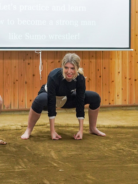Sumo wrestler teaching a participant in a Tokyo sumo wrestling experience.