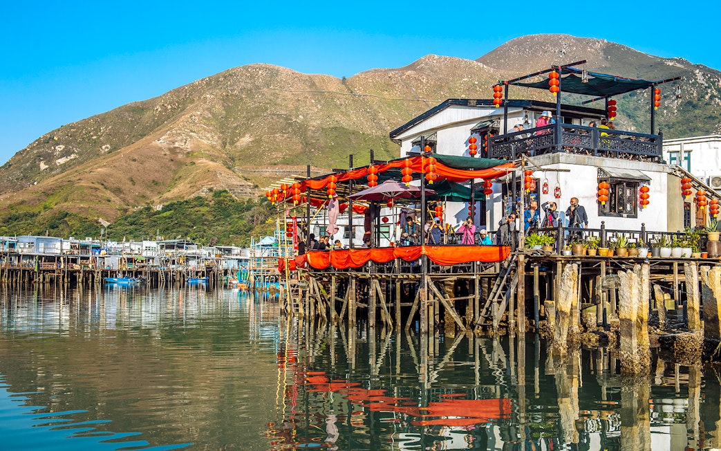 Stilt houses decorated with lanterns on Lantau Island during Ngong Ping Cable Car Ride tour.