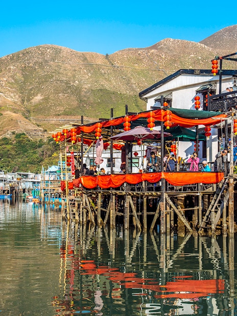 Stilt houses decorated with lanterns on Lantau Island during Ngong Ping Cable Car Ride tour.