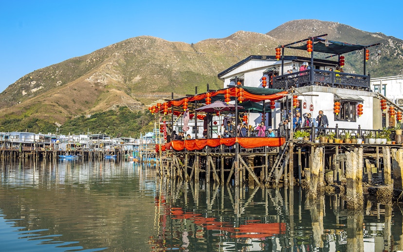 Stilt houses decorated with lanterns on Lantau Island during Ngong Ping Cable Car Ride tour.