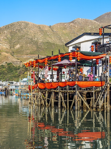 Stilt houses decorated with lanterns on Lantau Island during Ngong Ping Cable Car Ride tour.