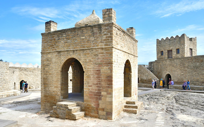 Ateshgah Fire Temple in Baku, Azerbaijan, with visitors exploring the historic site.