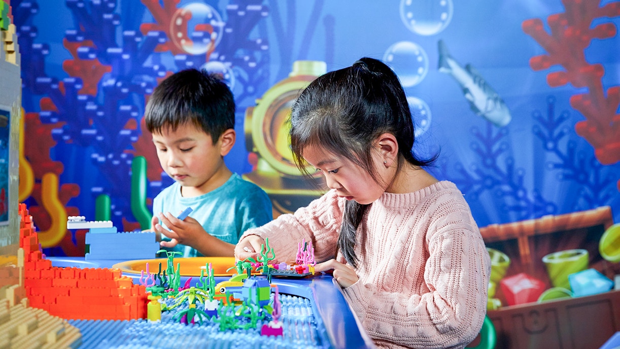 Kids playing with colorful LEGO sculptures at LEGOLAND Discovery Centre in Melbourne, Australia.