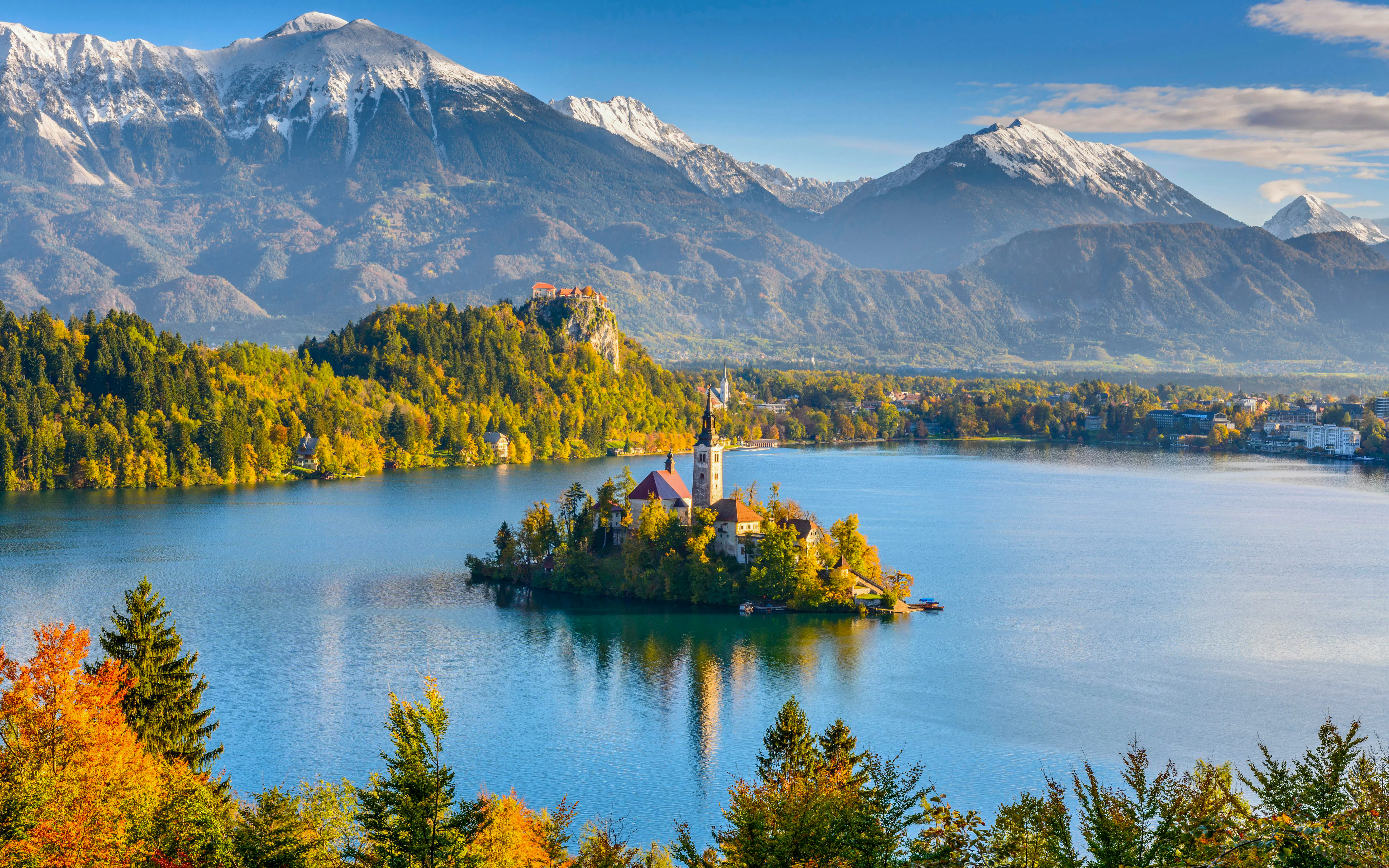 Panoramic view of Lake Bled with island church and Julian Alps from Mt Osojnica, Slovenia.