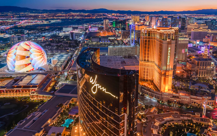 Las Vegas Strip aerial view at night with illuminated hotels and attractions.