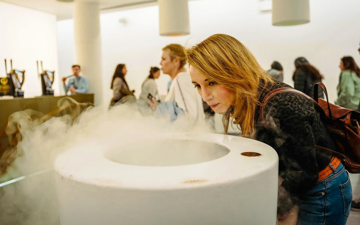 Visitor engaging with mist exhibit at Storehouse interactive display.