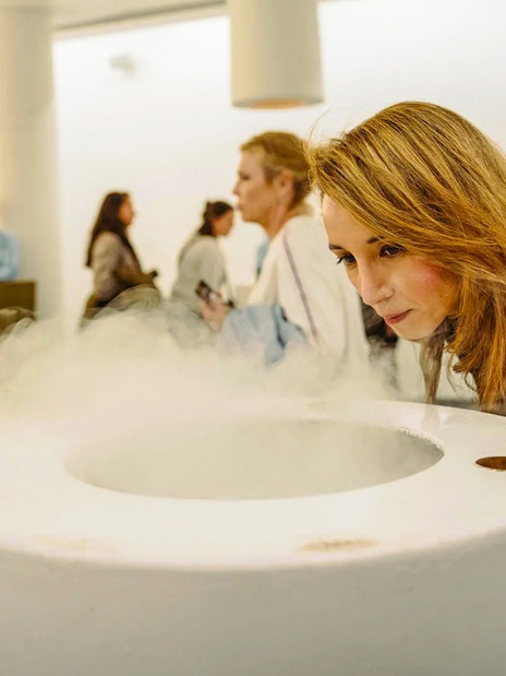 Visitor engaging with mist exhibit at Storehouse interactive display.