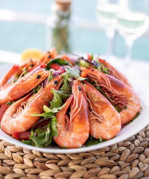 Plate of fresh prawns with greens on Moreton Island tour.