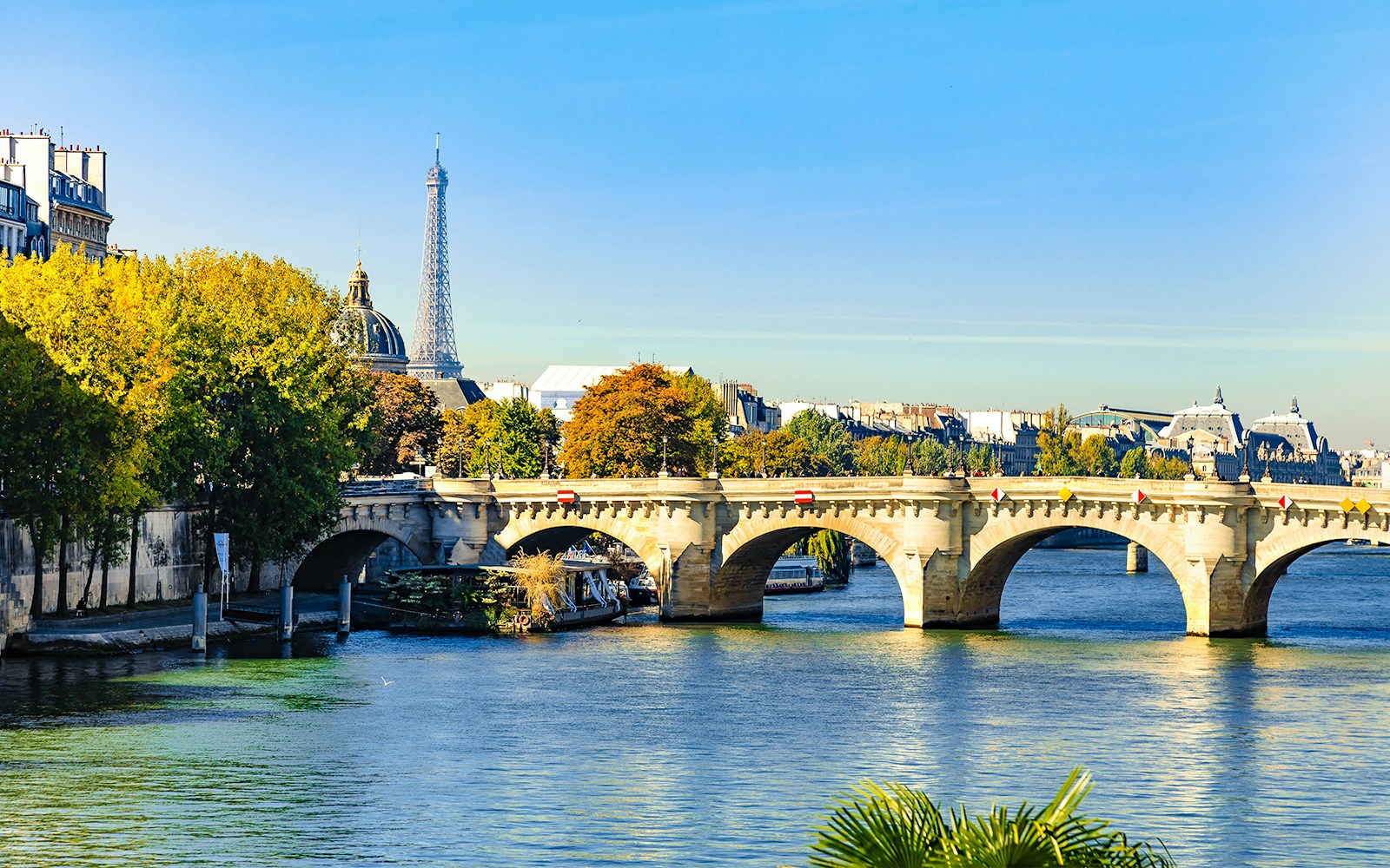 Pont Neuf bridge spanning the Seine River in Paris, France, with historic architecture.