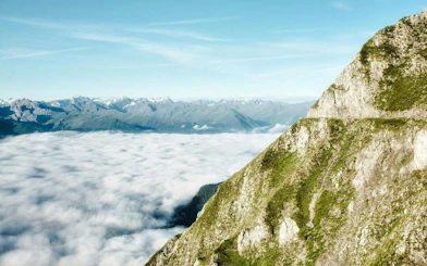 View of the Alps from Top of Innsbruck with clouds below.