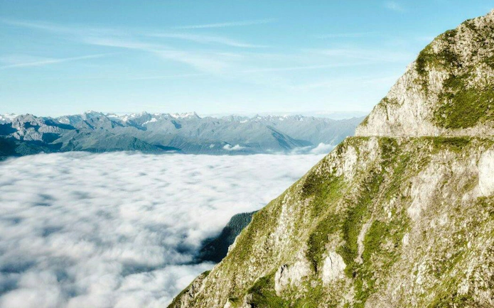 View of the Alps from Top of Innsbruck with clouds below.