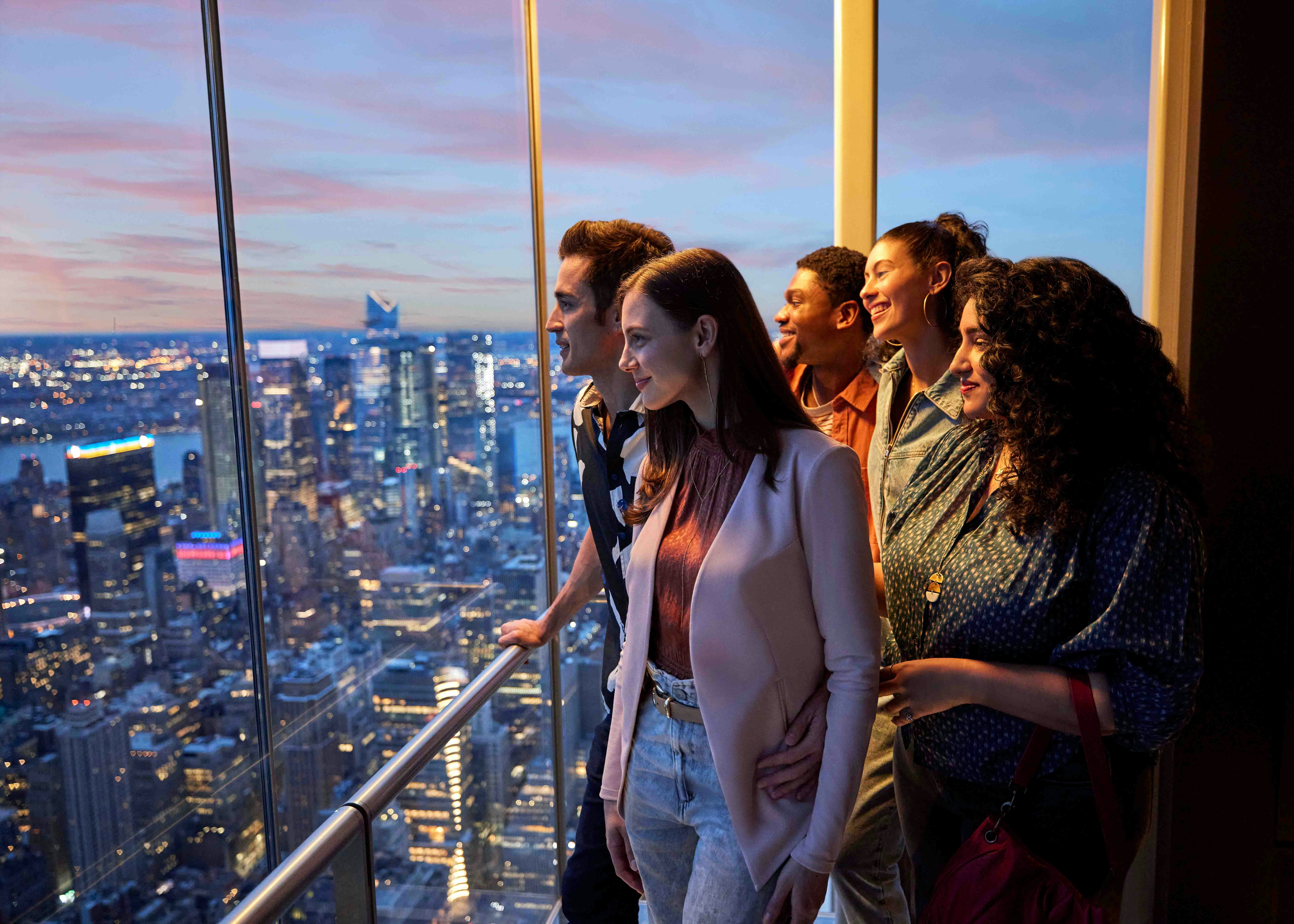 Visitors enjoying panoramic views from Summit One Vanderbilt observatory in New York City.