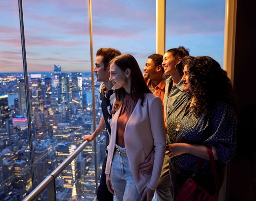 Visitors enjoying panoramic views from Summit One Vanderbilt observatory in New York City.