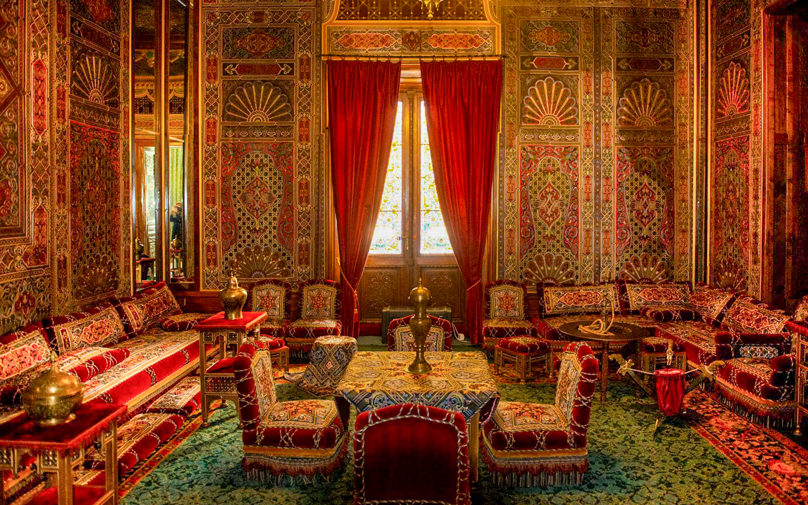 Turkish room with ornate decor and red furnishings inside Peles Castle, Romania.