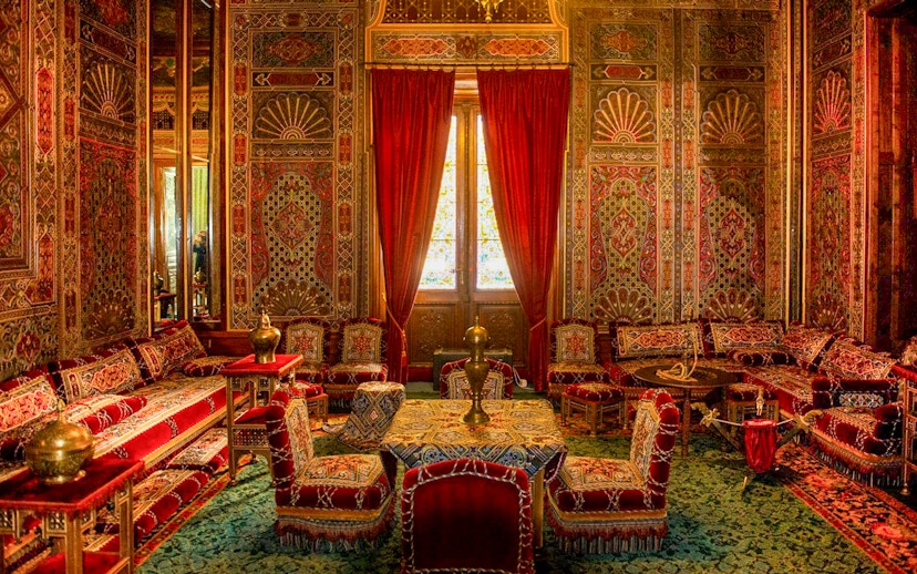 Turkish room with ornate decor and red furnishings inside Peles Castle, Romania.