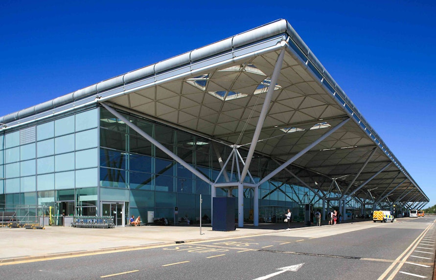Shuttle bus area at London Stansted Airport terminal for one-way tickets to London Stratford.