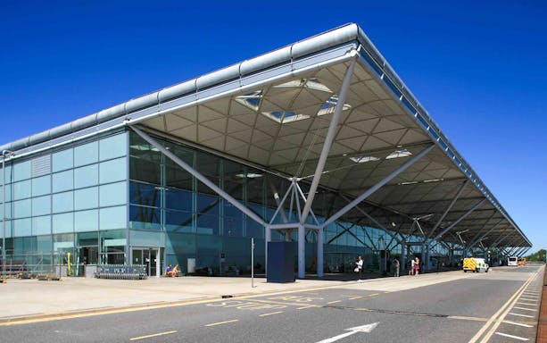 Shuttle bus area at London Stansted Airport terminal for one-way tickets to London Stratford.