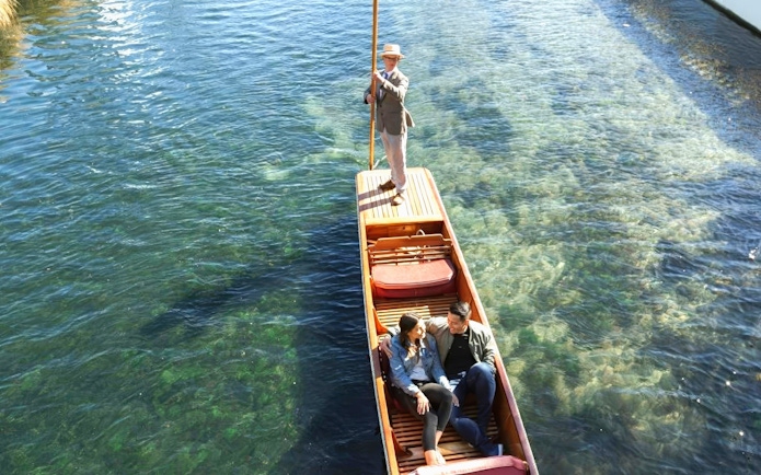 Couple enjoying a punting ride on the Avon River, Christchurch.