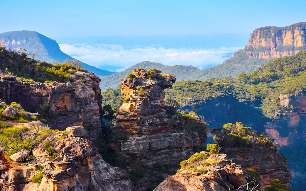 Boars Head rock formation in Blue Mountains, Australia, surrounded by lush greenery and cliffs.