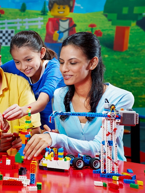 Children building with Lego bricks at Legoland Dubai.