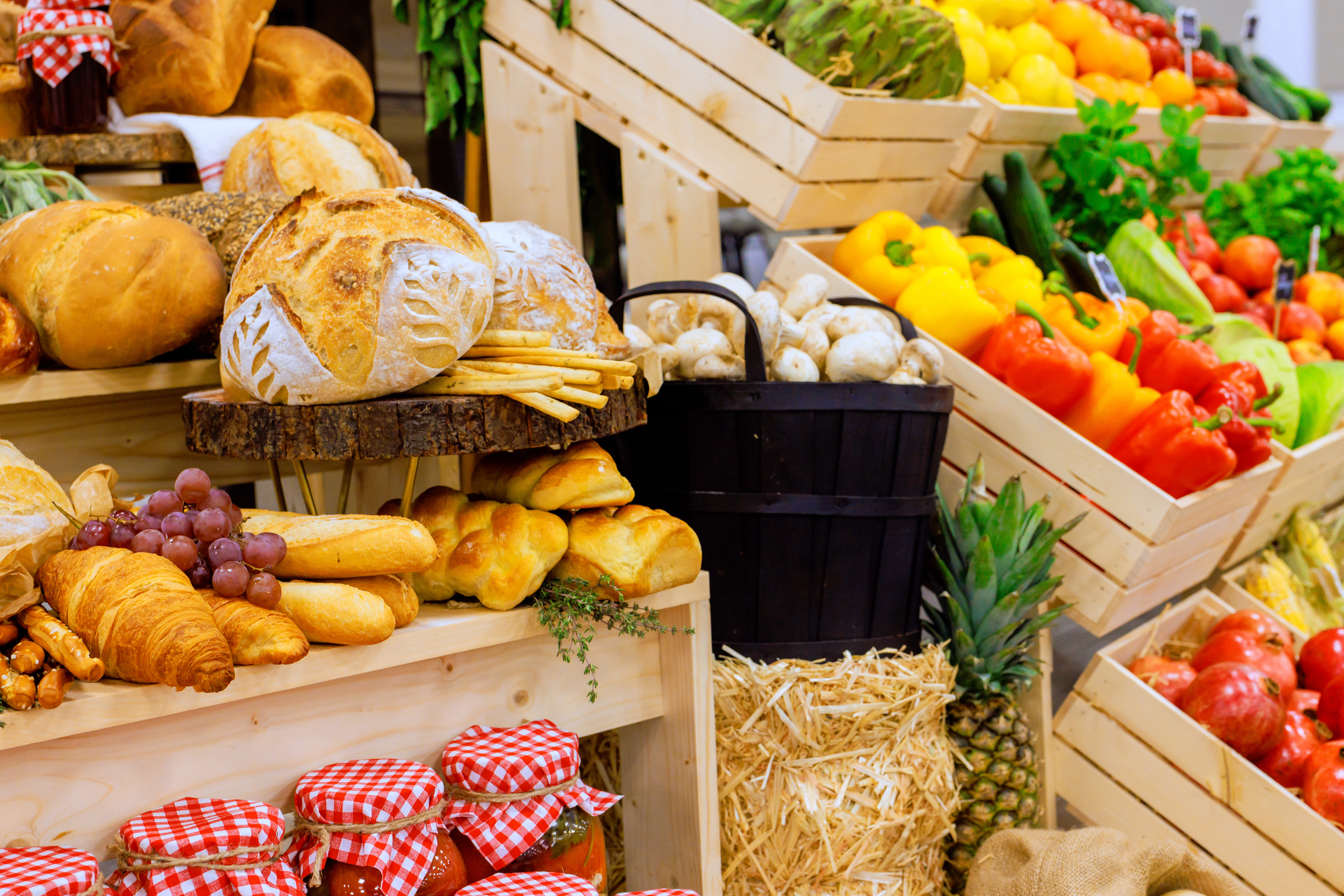 Farmers market display with colorful fruits, vegetables, and freshly baked bread.