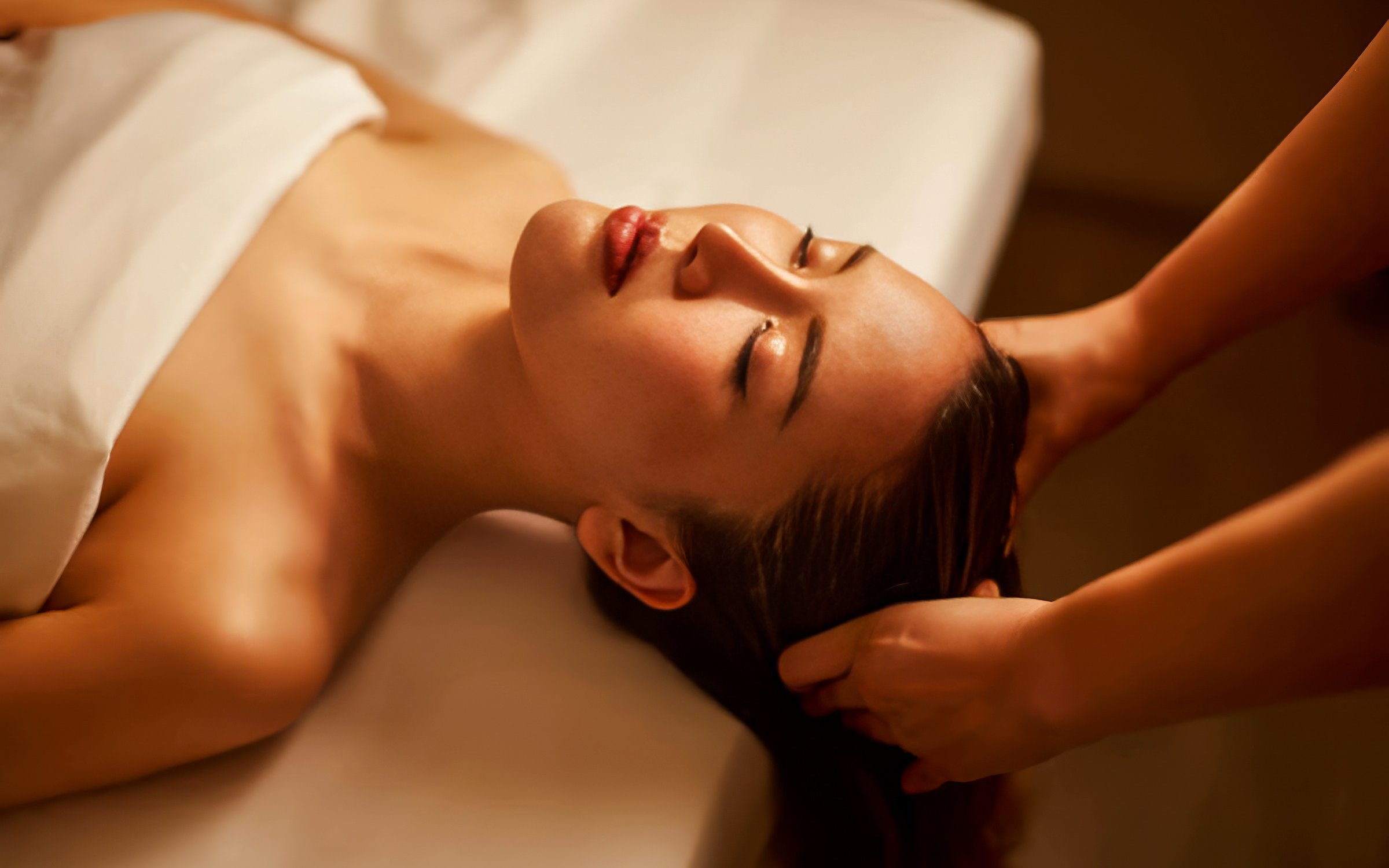 Woman receiving Diora Signature Body Scrub treatment.