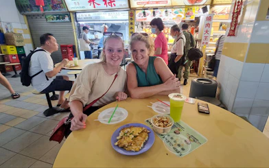 Visitors enjoying local cuisine at a food stall during the Bike and Bites Food Tour.