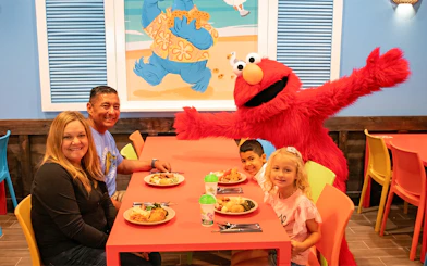 Family dining with Elmo at Sesame Place San Diego.