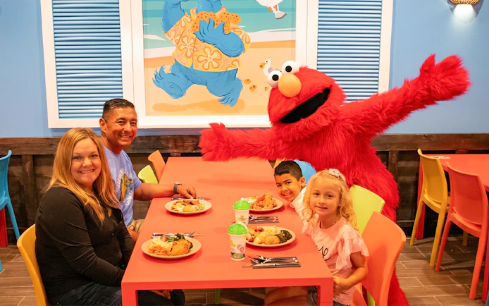 Family dining with Elmo at Sesame Place San Diego.
