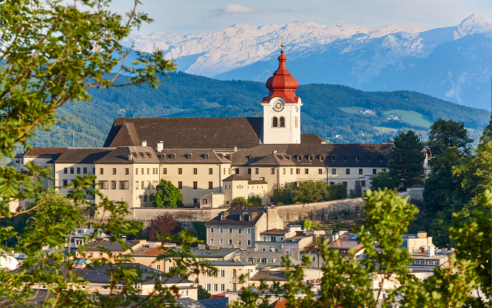 Nonnberg Abbey with alpine range backdrop in Salzburg.