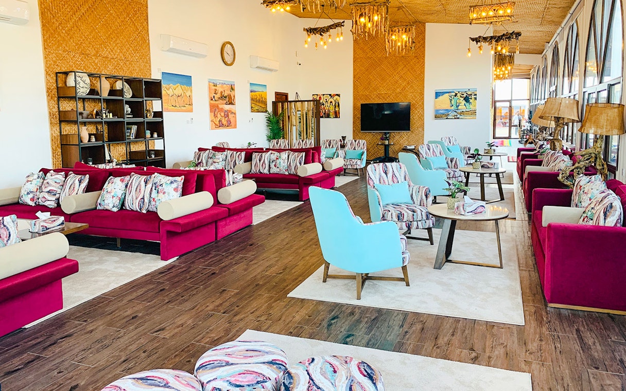 Spacious lounge area at Al Majles Resort with colorful seating and decor.