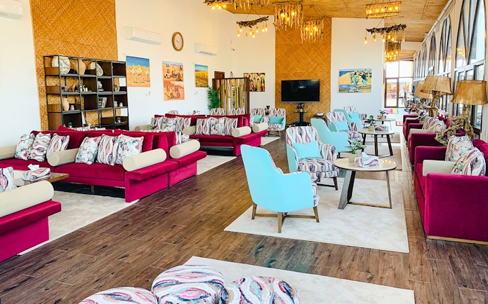 Spacious lounge area at Al Majles Resort with colorful seating and decor.
