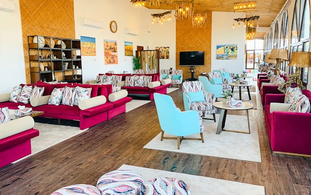 Spacious lounge area at Al Majles Resort with colorful seating and decor.