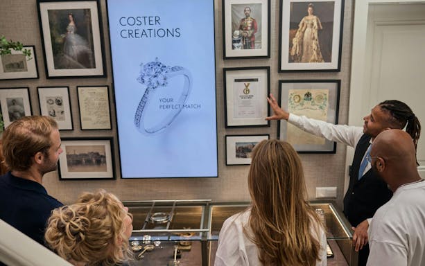 Visitors viewing diamond display at Royal Coster Diamonds showroom.