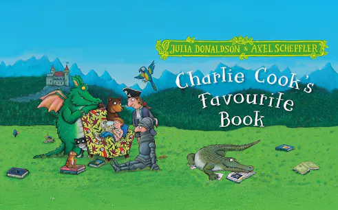 Characters gathered around a book in a grassy field with a castle in the background.